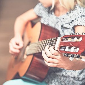 Close up of a girl playing a guitar